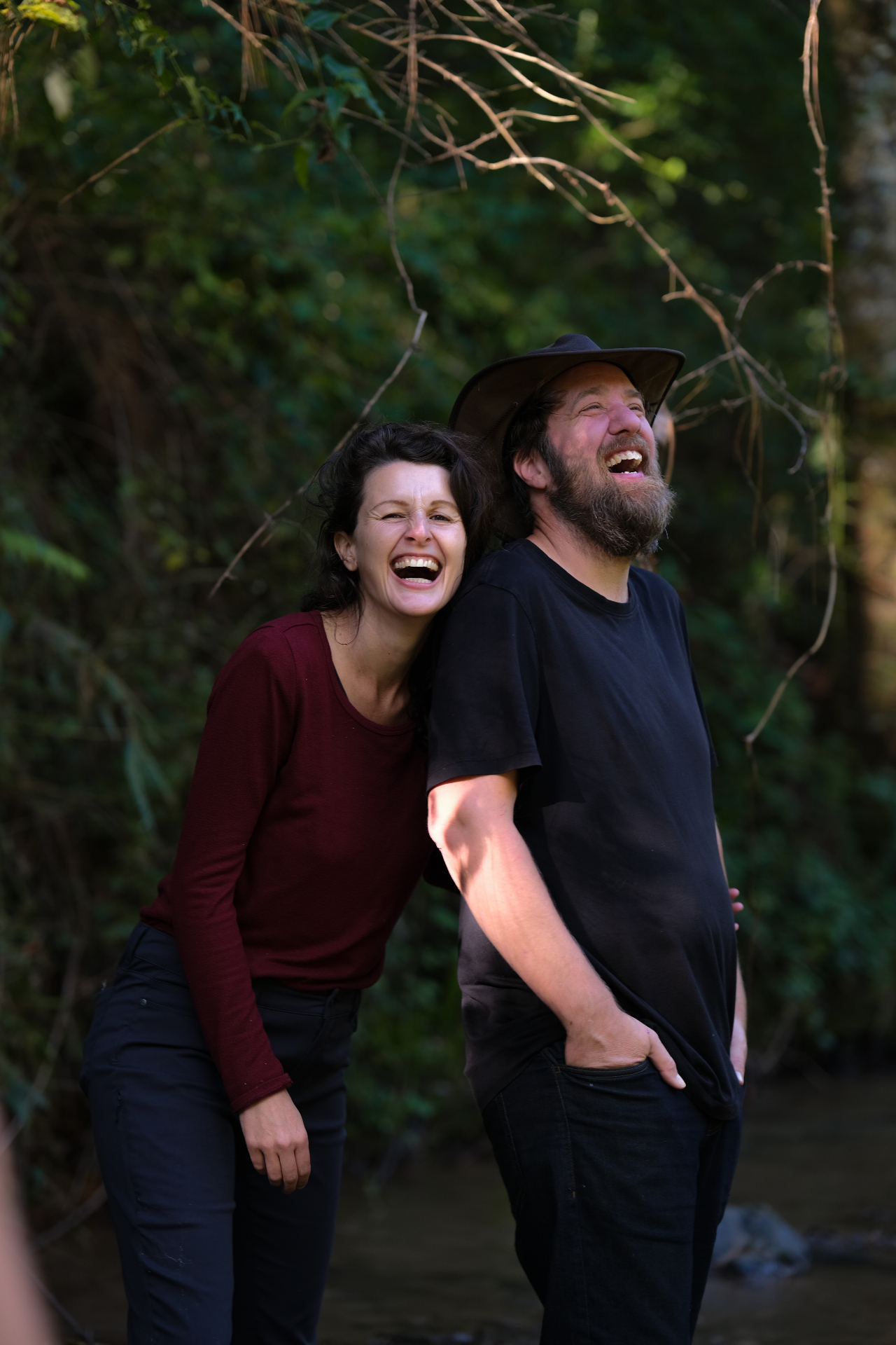 Jo and Scott laughing together by a creek